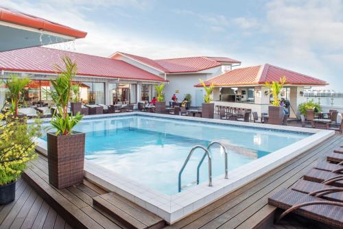 a pool on the deck of a hotel at Ramada by Wyndham Princess Paramaribo in Paramaribo