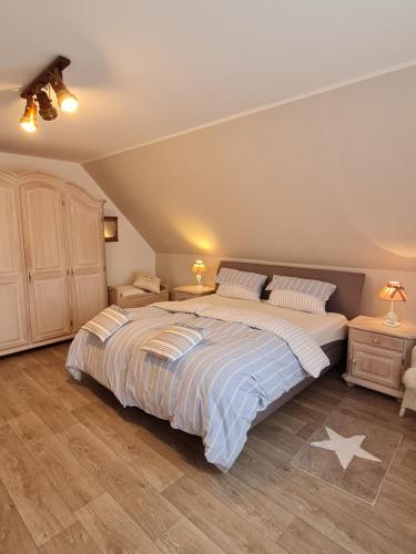 a bedroom with a large bed and two night stands at Apartment Seaside in Husum