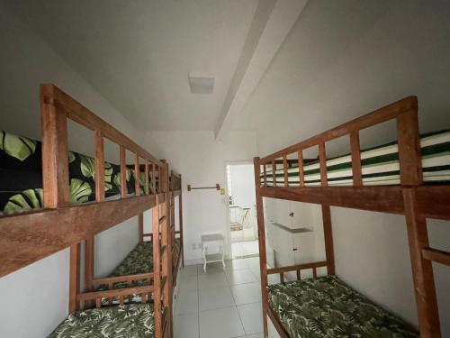 a room with three bunk beds in a room at Solcity Hostel in Salvador