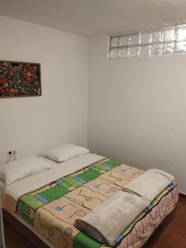 a bedroom with a bed with a quilt on it at DCK Apartments in Kostrena