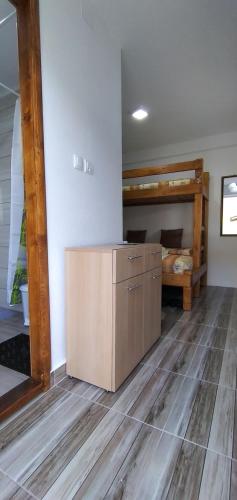 a room with a wooden floor and a bunk bed at Apartman na Drini in Foča