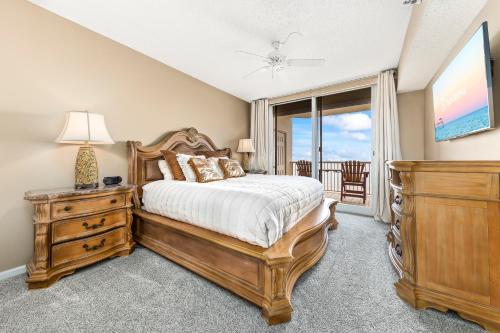 a bedroom with a bed and a dresser and a window at Beach Club 708D in Gulf Shores