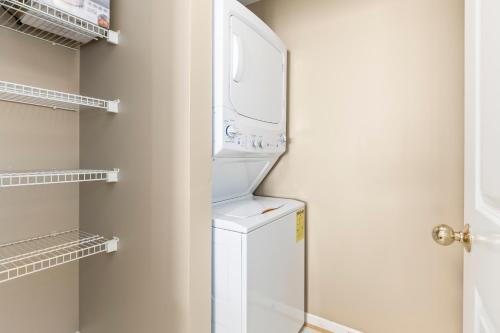 a laundry room with a washer and dryer at Beach Club 708D in Gulf Shores