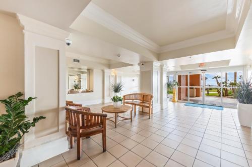 a living room with chairs and a table at Beach Club 708D in Gulf Shores