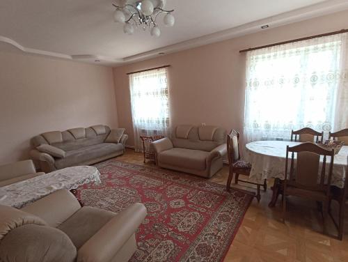 a living room with a couch and a table and chairs at Green Garden in Ijevan