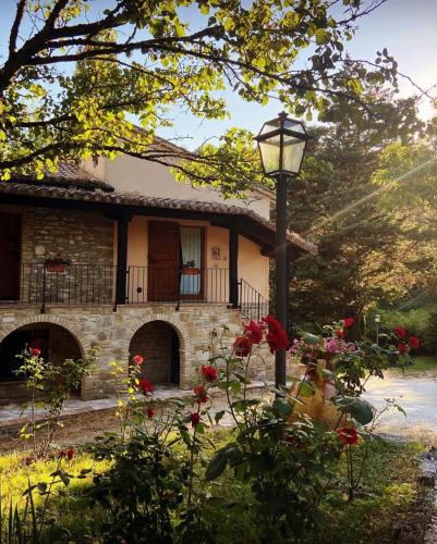a house with a street light in front of it at Agriturismo Le Querce di Assisi in Assisi