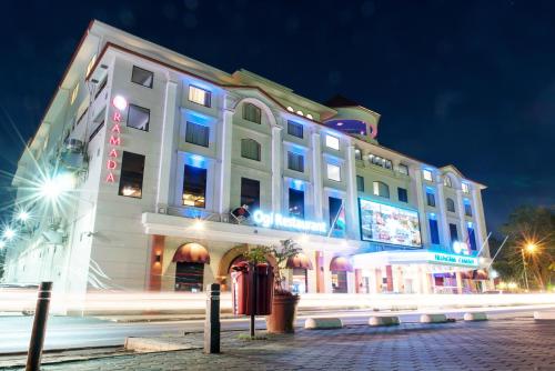 a large white building with lights on it at night at Ramada by Wyndham Princess Paramaribo in Paramaribo