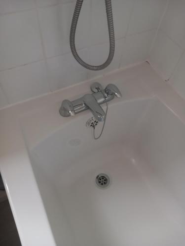 a bath tub with a faucet and a shower at 32 Elder Drive Chester CH4 8PD in Chester