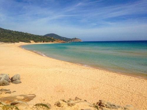 a beach with the ocean and some rocks in the sand at Private Pool villa with panoramic views split over 2 levels / Aircon / New Pool. in Chia