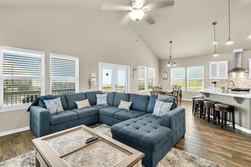 a living room with a blue couch and a kitchen at The Blue Pelican in Corpus Christi