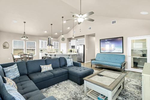 a living room with a blue couch and a kitchen at The Blue Pelican in Corpus Christi