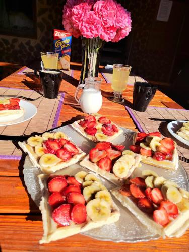 a table topped with sandwiches with fruit and milk at U Vodníka in Mohelnice