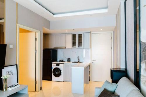 a kitchen with a washer and dryer in a room at kimaya at Benson Pakuwon Mall in Surabaya