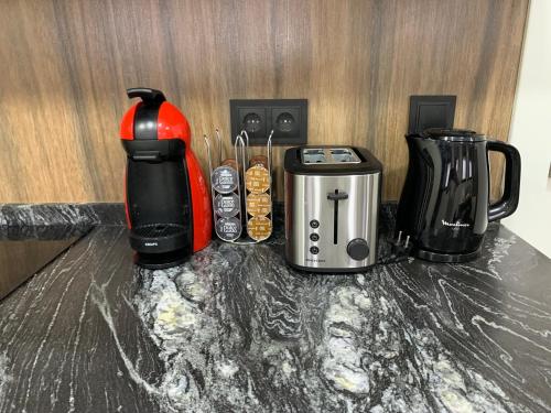 a coffee maker and a toaster on a counter at Casa Rural en Santa Cruz-Mieres in Bustiello