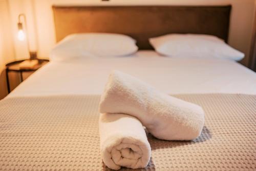 a white towel sitting on top of a bed at Seascape House in Kremasti