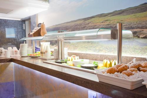 a buffet line with food in a restaurant at Mix Peymar in S'Illot