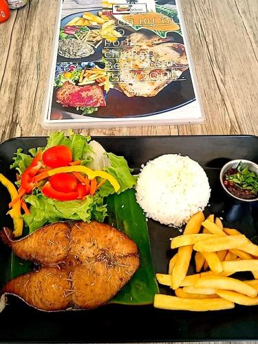 a plate of food with rice and meat and vegetables at Mateoasis in Ko Kood
