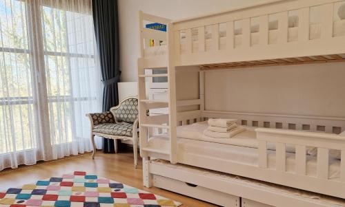 a bedroom with two bunk beds and a chair at Ferienwohnung Golfblick in Wittenbeck