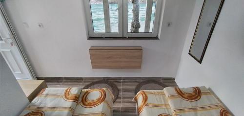 a room with a bed and two chairs in it at Apartman na Drini in Foča