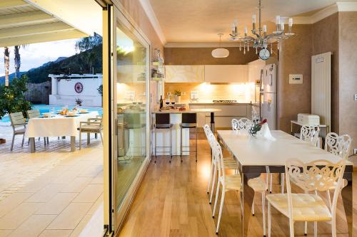 a kitchen and dining room with a table and chairs at Villa Luce in Letojanni