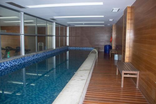 a swimming pool with a bench in a building at Flat vision in Brasilia