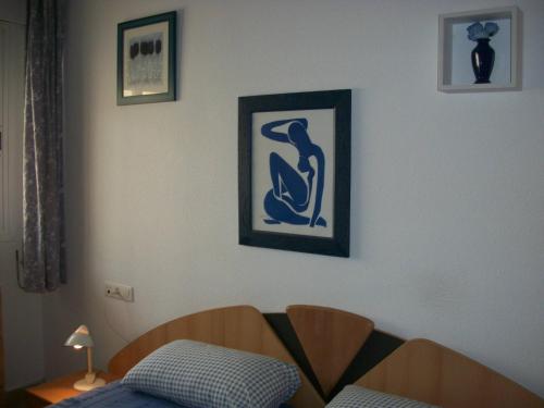 a bedroom with a bed and a picture on the wall at 1 Bedroom Penthouse On Front Line Of The Beach in Roquetas de Mar