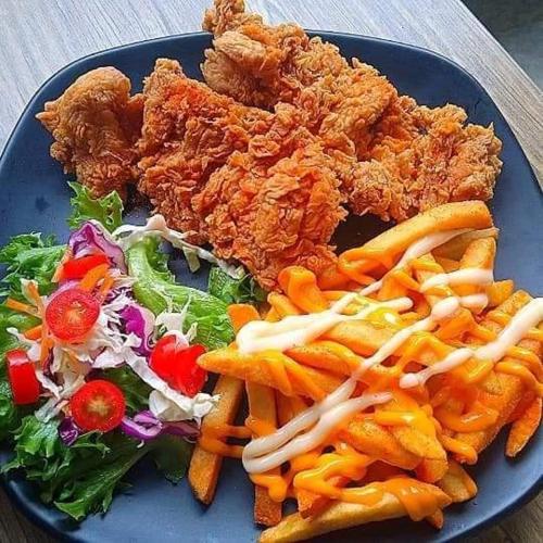 a blue plate of food with chicken and a salad at Mateoasis in Ko Kood