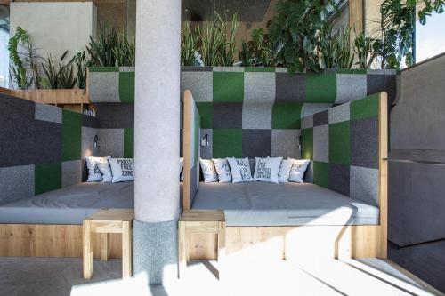 two beds on a balcony with plants at Hotel Arlmont 4 Stern Superior in Sankt Anton am Arlberg