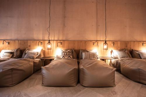 a room with couches and tables with lights at Hotel Arlmont 4 Stern Superior in Sankt Anton am Arlberg