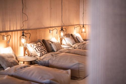 a row of beds in a room with lights at Hotel Arlmont 4 Stern Superior in Sankt Anton am Arlberg
