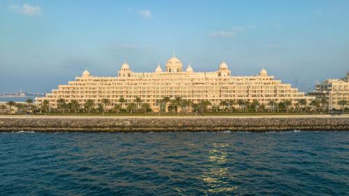 a large building sitting next to the water at Kempinski Hotel & Residences Palm Jumeirah in Dubai