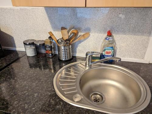a kitchen counter with a sink and utensils at 1 Bedroom Studio in a Supurb Area of Cardiff in Cardiff