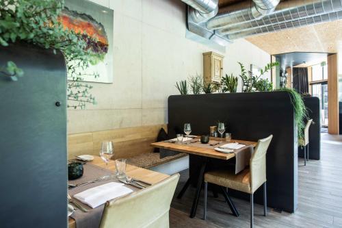a restaurant with a wooden table and chairs and a table and chairsktop at Hotel Arlmont 4 Stern Superior in Sankt Anton am Arlberg