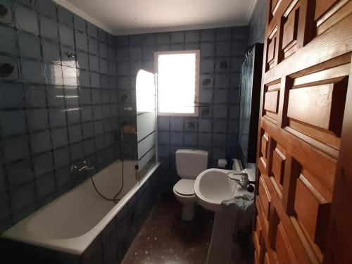 a bathroom with a toilet and a tub and a sink at Valencia Countryside Villa in Valencia