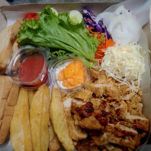 a plate of food with french fries and vegetables at Mateoasis in Ko Kood