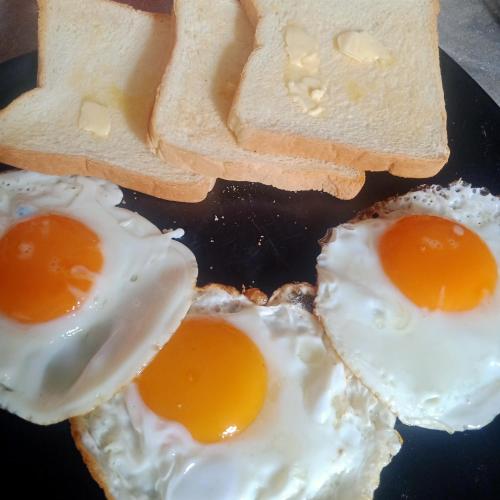 two fried eggs and toast on a plate at Mateoasis in Ko Kood