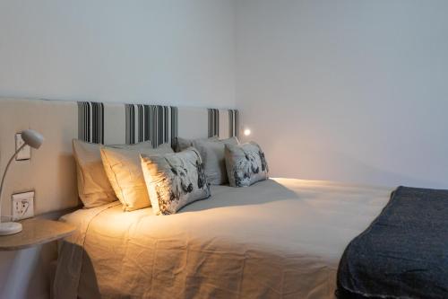 a bedroom with a white bed with pillows at Views over Wilderness in Wilderness
