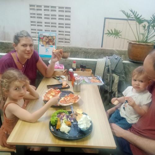 a group of people sitting at a table eating food at Mateoasis in Ko Kood
