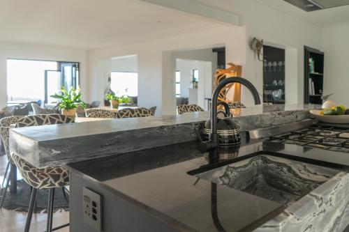 a kitchen with a sink and a counter top at Views over Wilderness in Wilderness