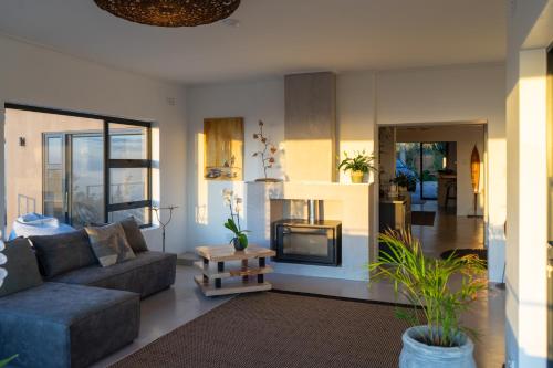 a living room with a couch and a fireplace at Views over Wilderness in Wilderness