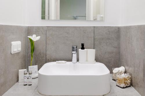 a bathroom with a white sink and a mirror at Rare! private garden in Paris, close to Sacre Coeur Basilica! in Paris