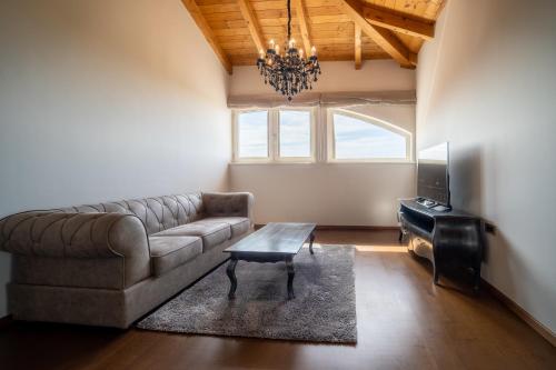a living room with a couch and a table at Wine Residence Cattunar in Brtonigla