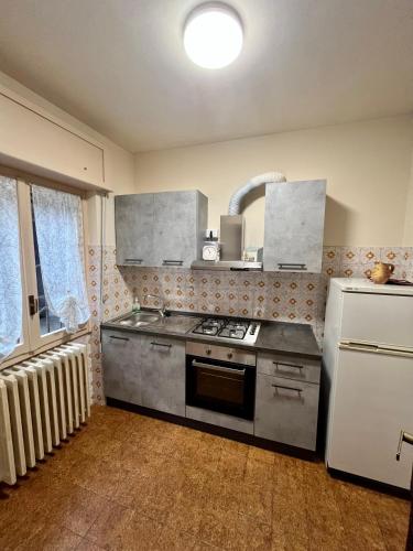 a kitchen with a stove and a refrigerator at La Locanda dell'Oreste in Dizzasco