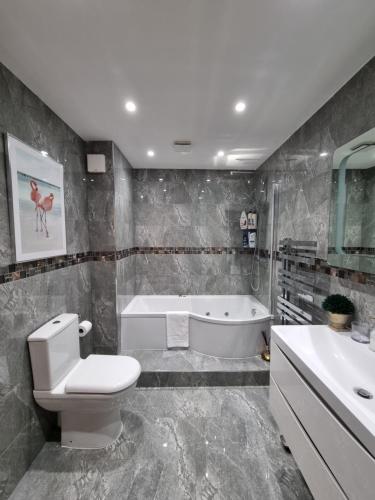 La salle de bains est pourvue de toilettes, d'une baignoire et d'un lavabo. dans l'établissement Jubilee house, à Londres