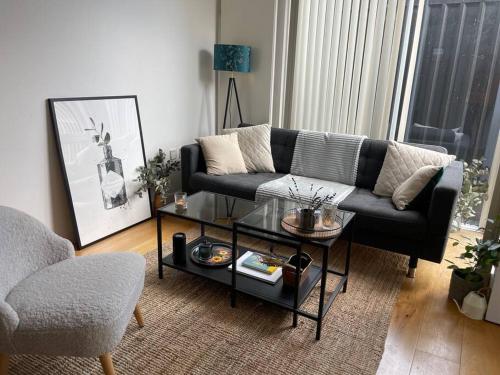 a living room with a couch and a coffee table at Shoreditch Cosy Flat, next to Van Gogh exhibition in London