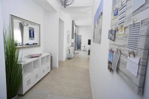 a hallway with a white bathroom with a wall with posters at Villa Patricia Playa Blanca in Playa Blanca