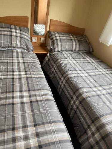 two beds sitting next to each other in a room at Croft View in Taynuilt