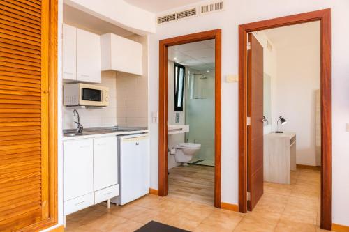 a kitchen with a sink and a toilet in a room at Apto con Terraza 403 in Cala Millor