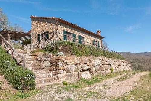 an old stone house on top of a stone wall at Podere in Volpaia in Radda in Chianti