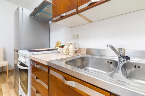 a kitchen with a sink and a stove at Guest House Marinna in Vrboska